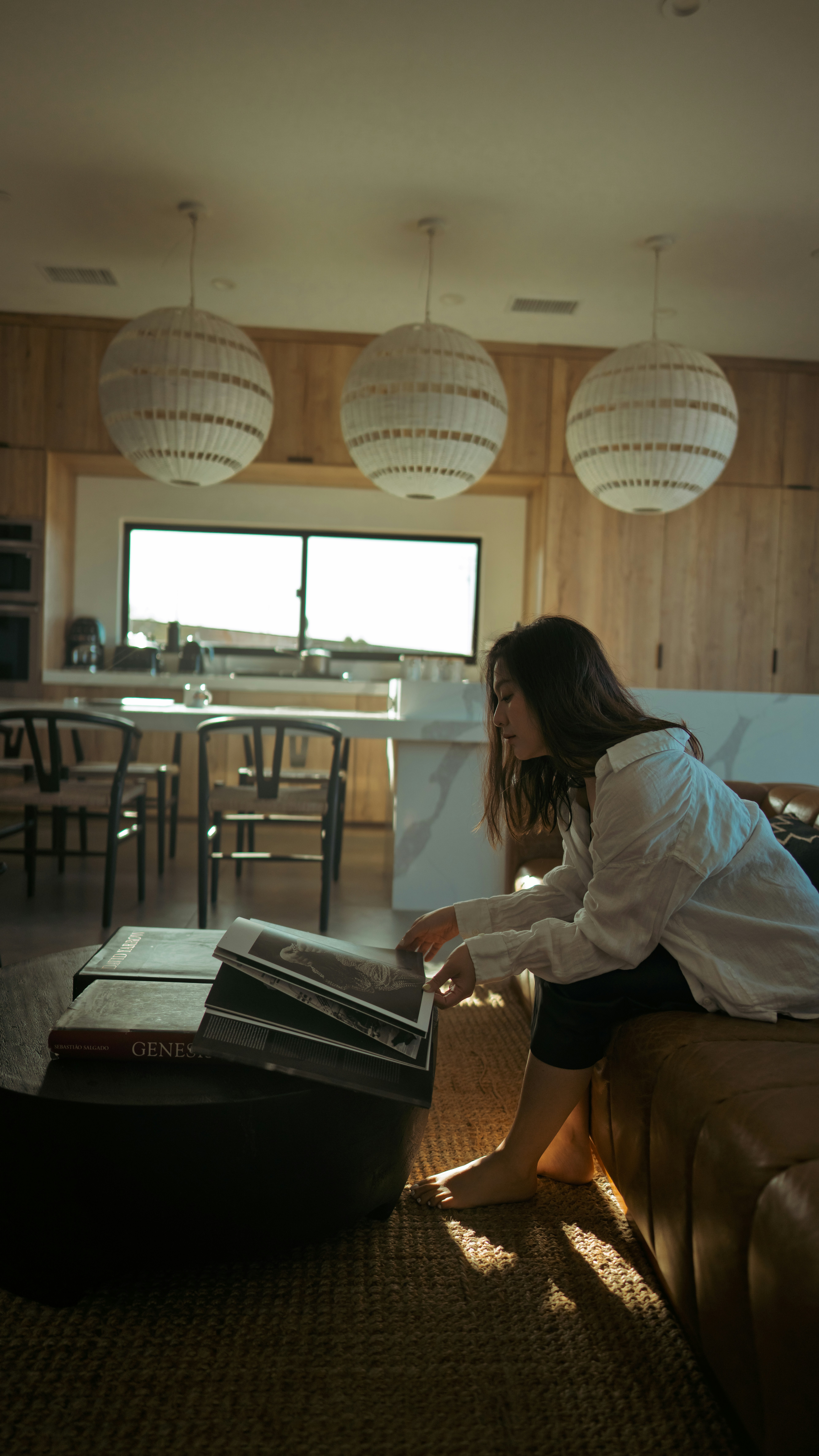 A woman reading a book on a couch.