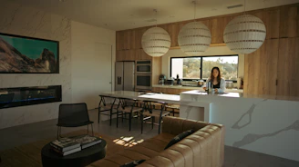 Woman standing in a modern kitchen and living area