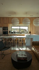 Modern kitchen and living area with natural light.
