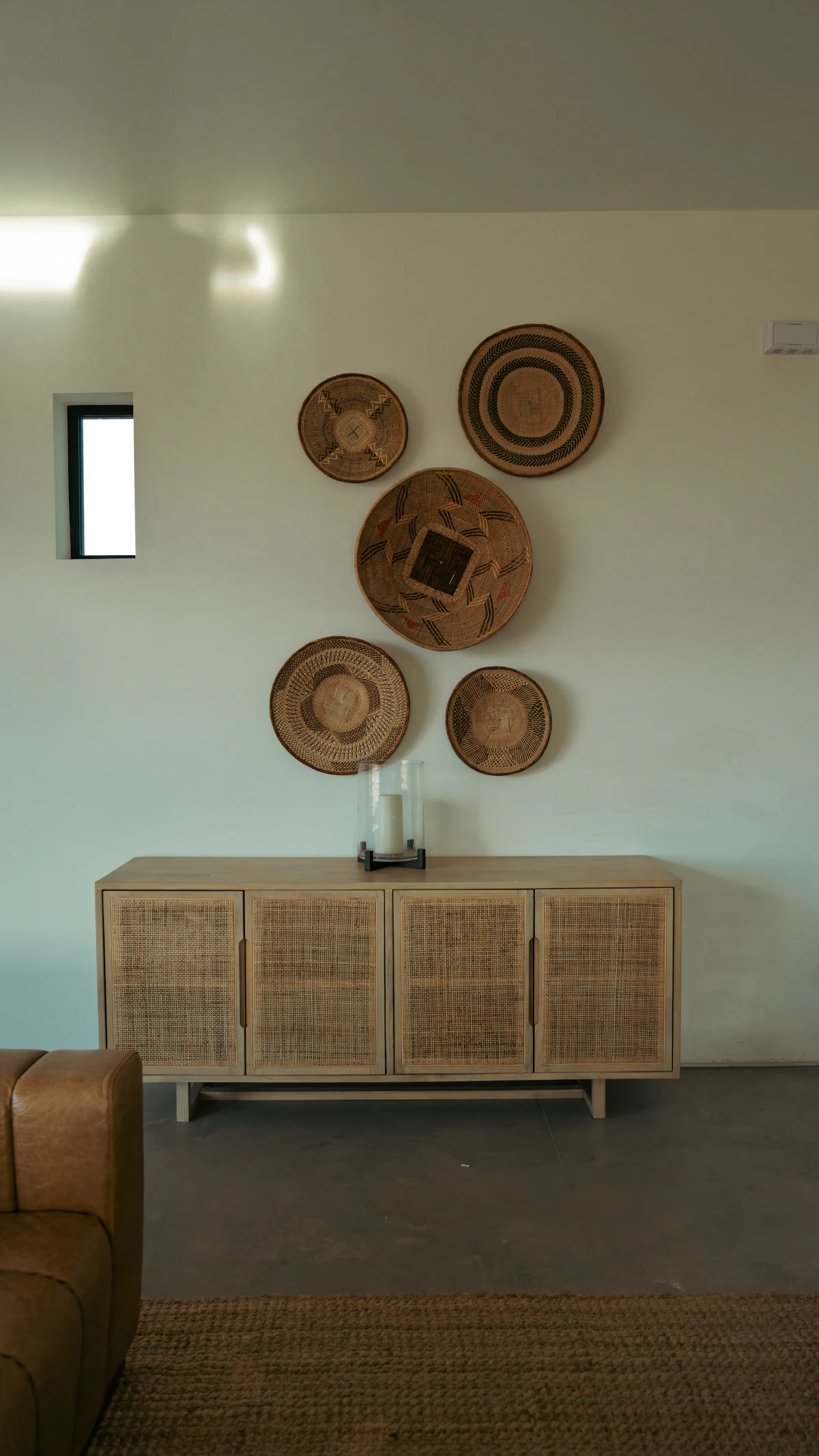 Woven basket storing throws in a small cozy lounge