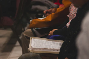 People are seated, some with notebooks open.