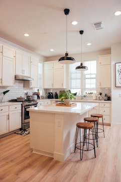 Modern white kitchen with island and bar stools