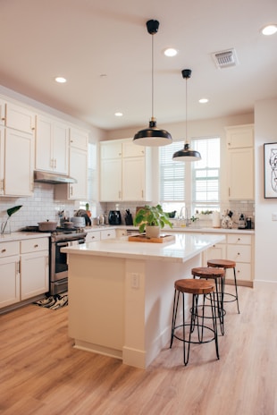 Modern white kitchen with island and bar stools