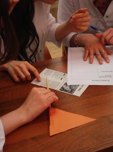 People are working together on a paper craft.