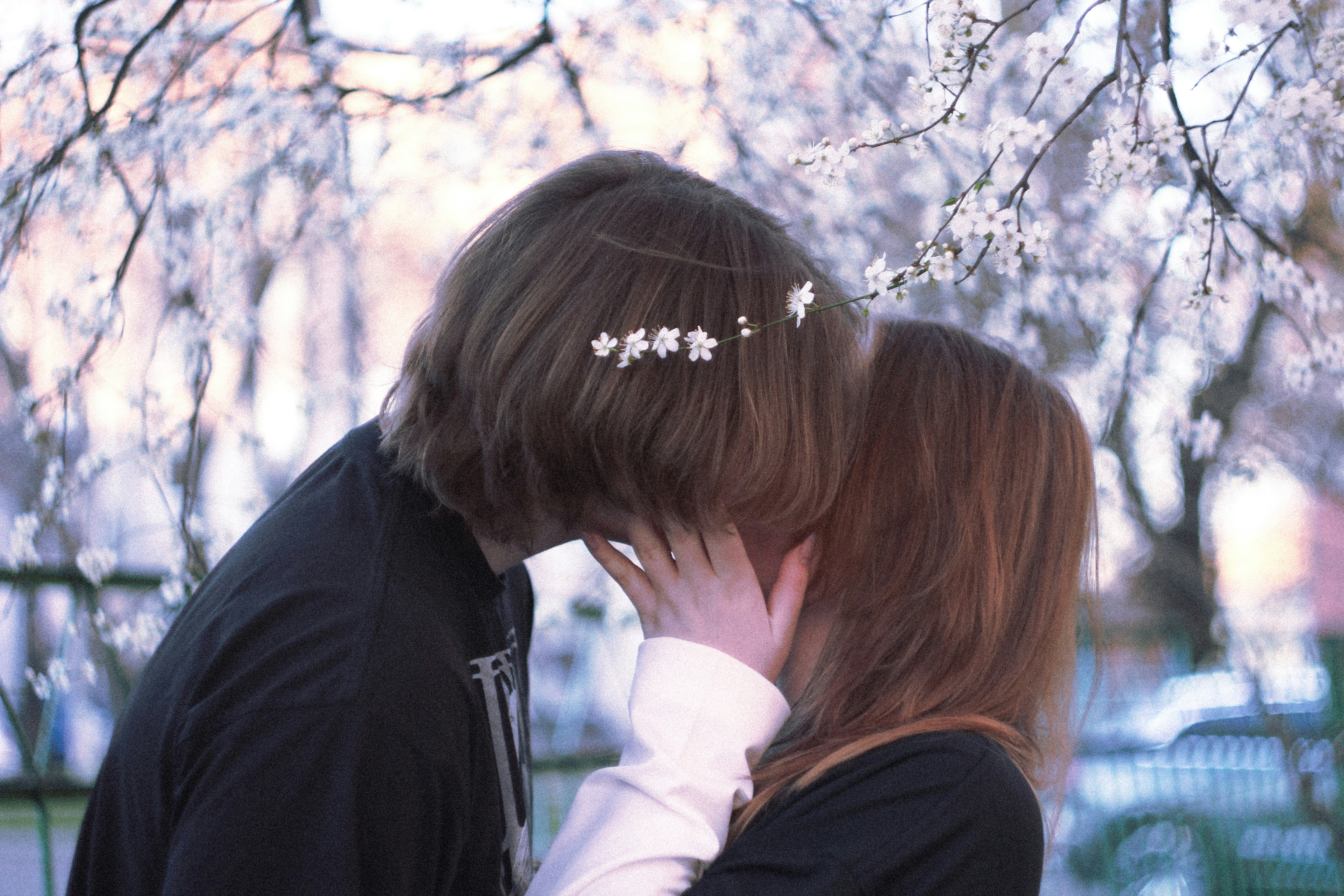 A couple shares a sweet, romantic kiss.