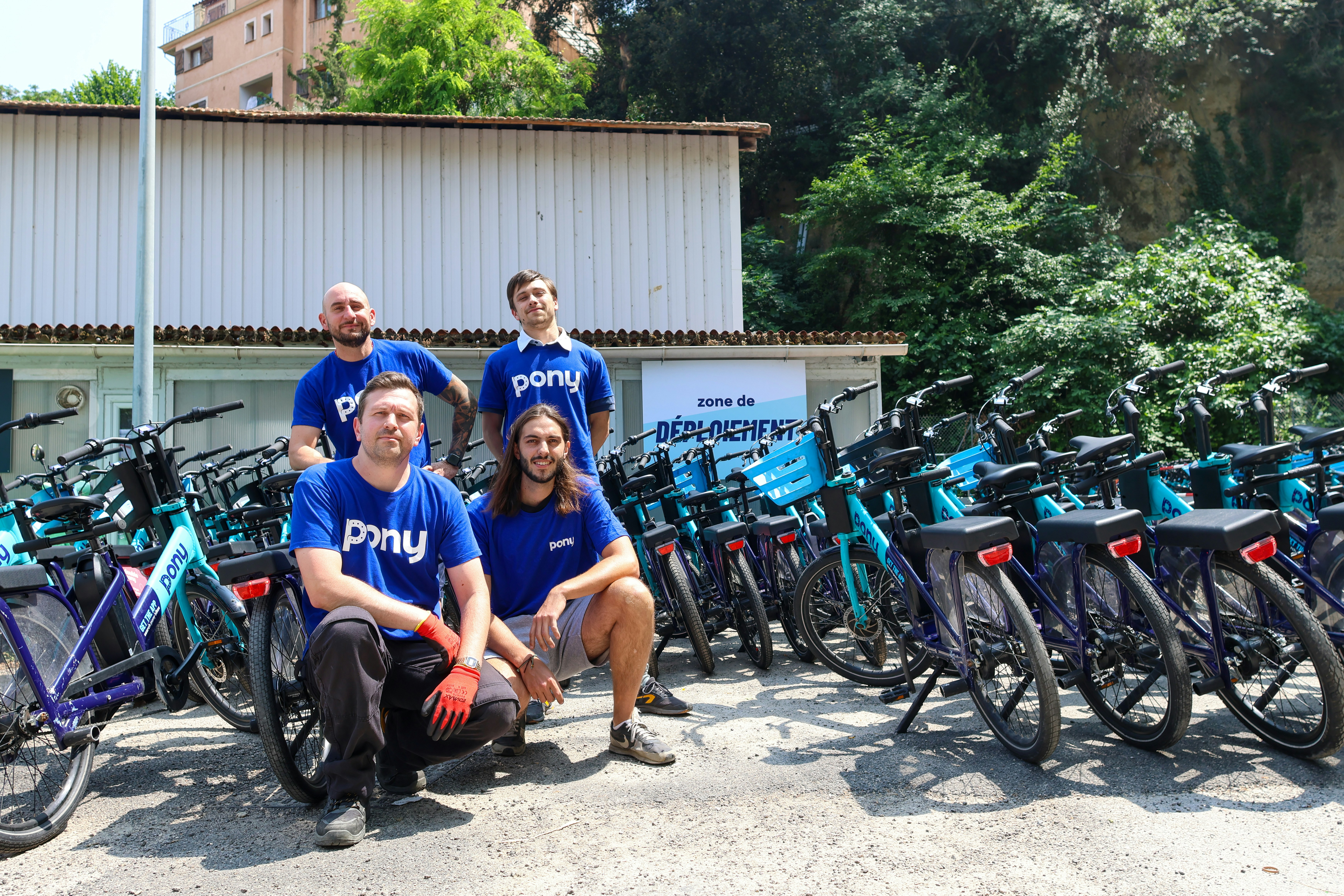 People pose with bikes ready for rentals.
