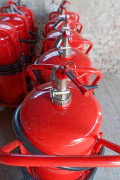 Several red fire extinguishers are lined up.