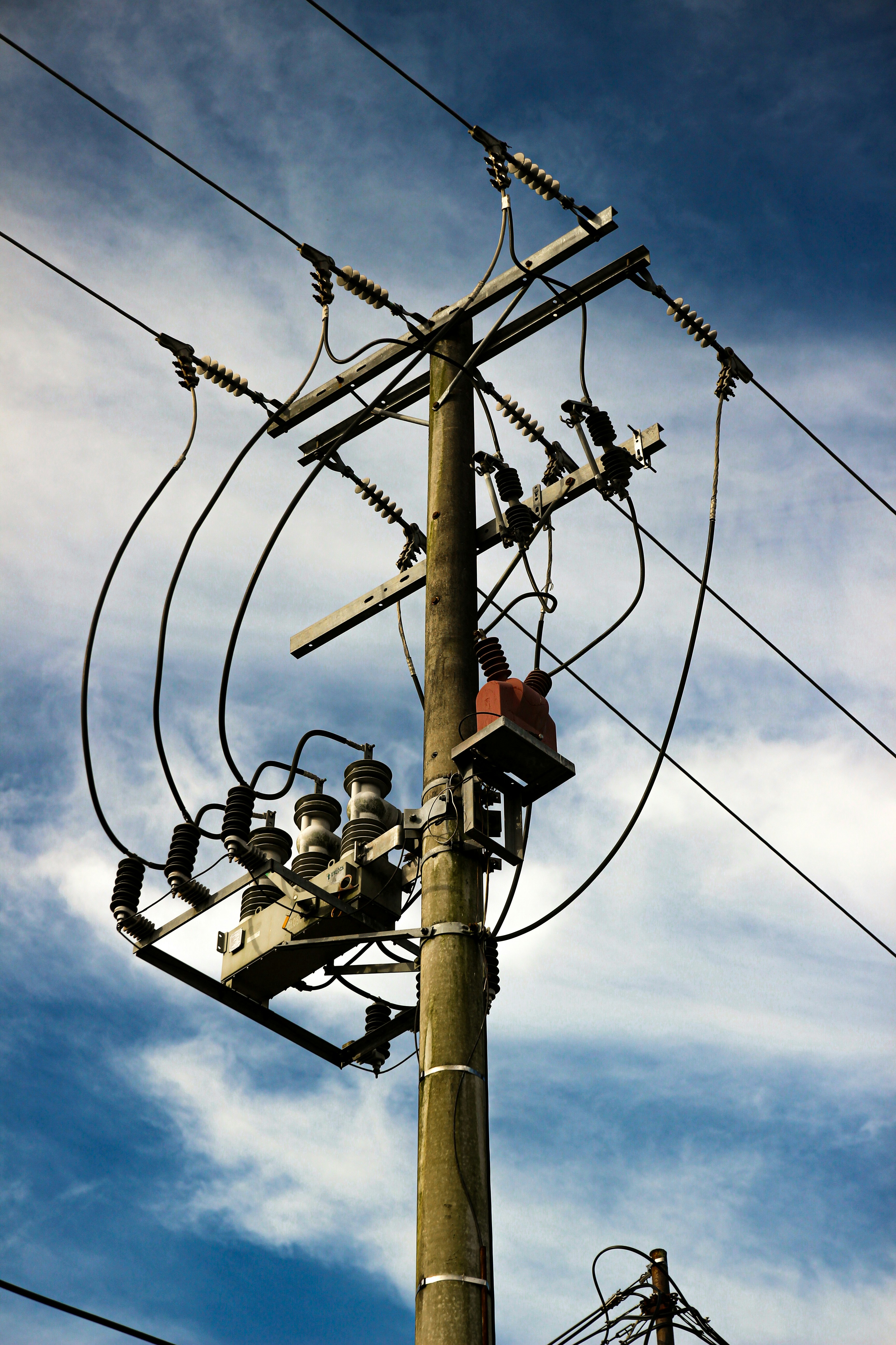 Power lines and electrical equipment on a pole.