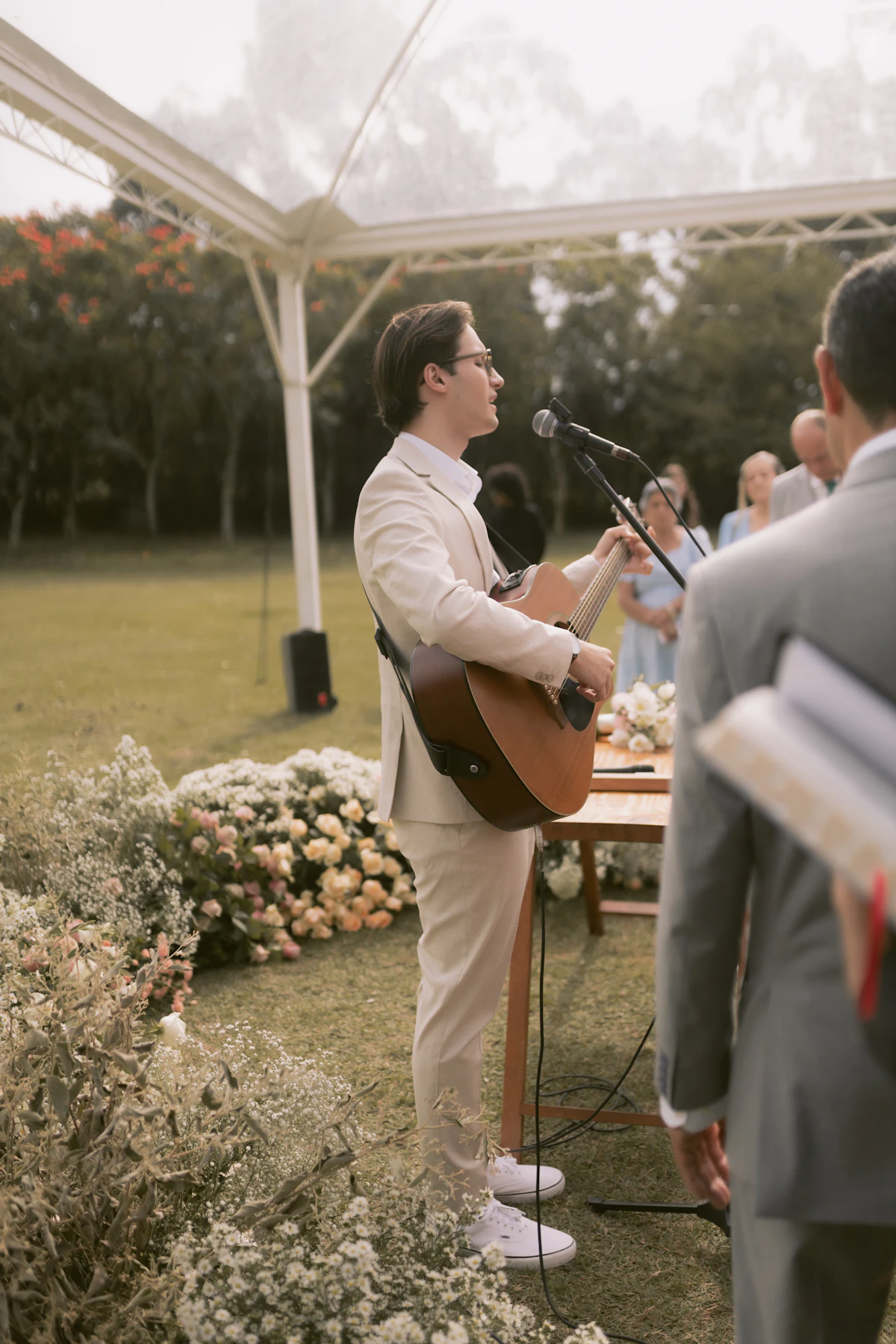 A musician playing at an outdoor wedding ceremony