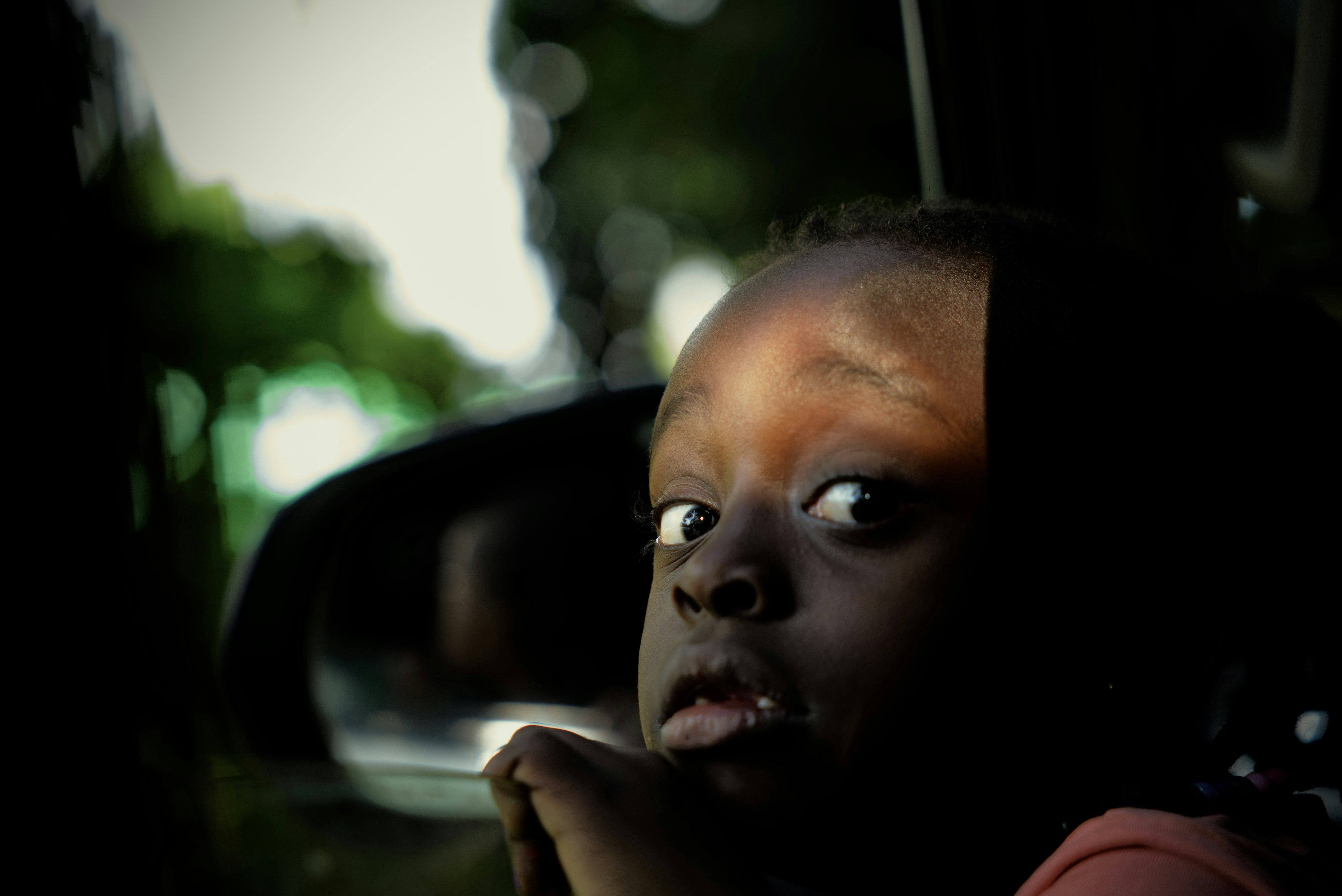 Un niño mira por la ventanilla de un coche.