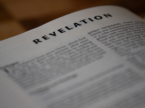 The image shows a close-up of the book of revelation.