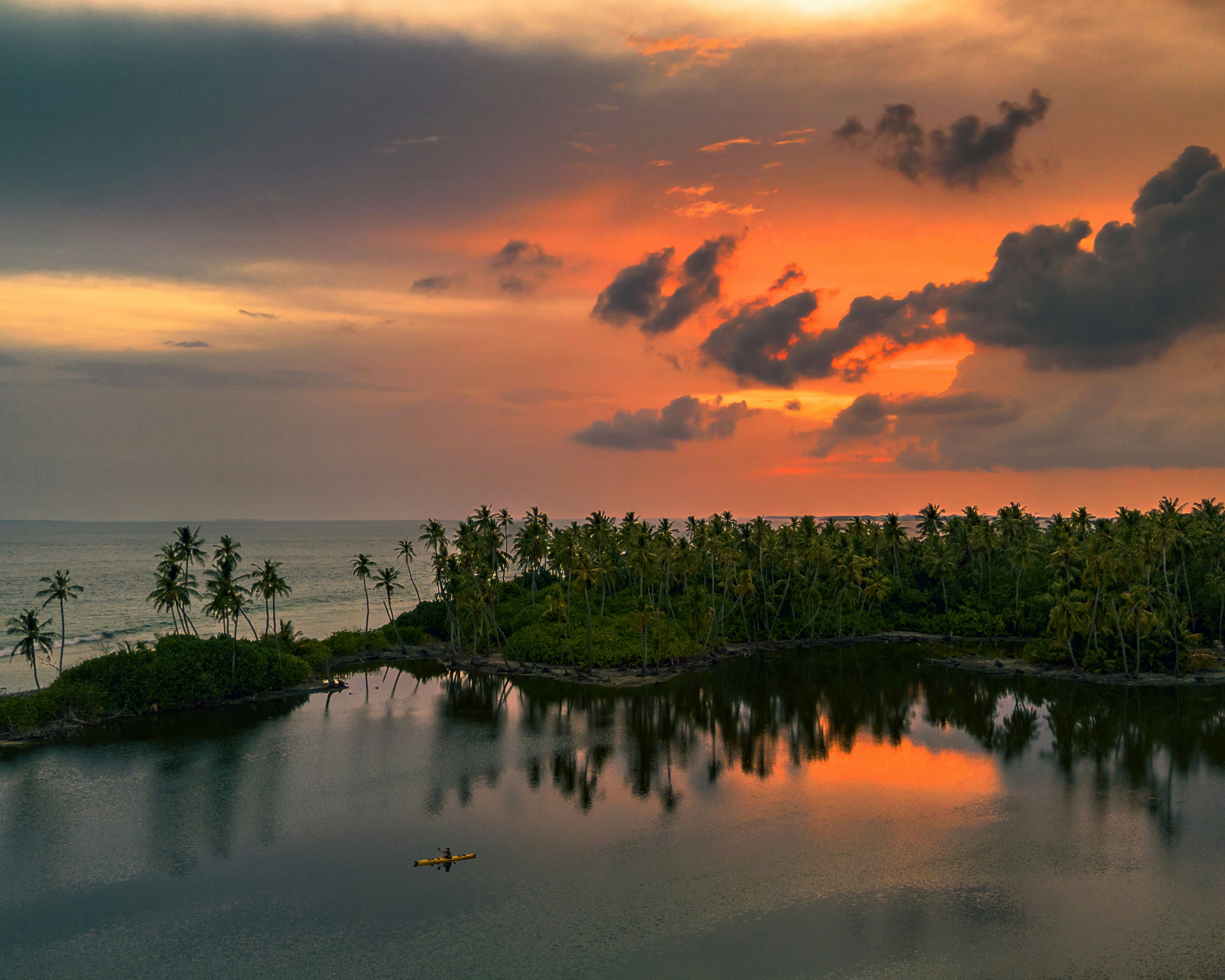Sunset paints the sky over tranquil waters.