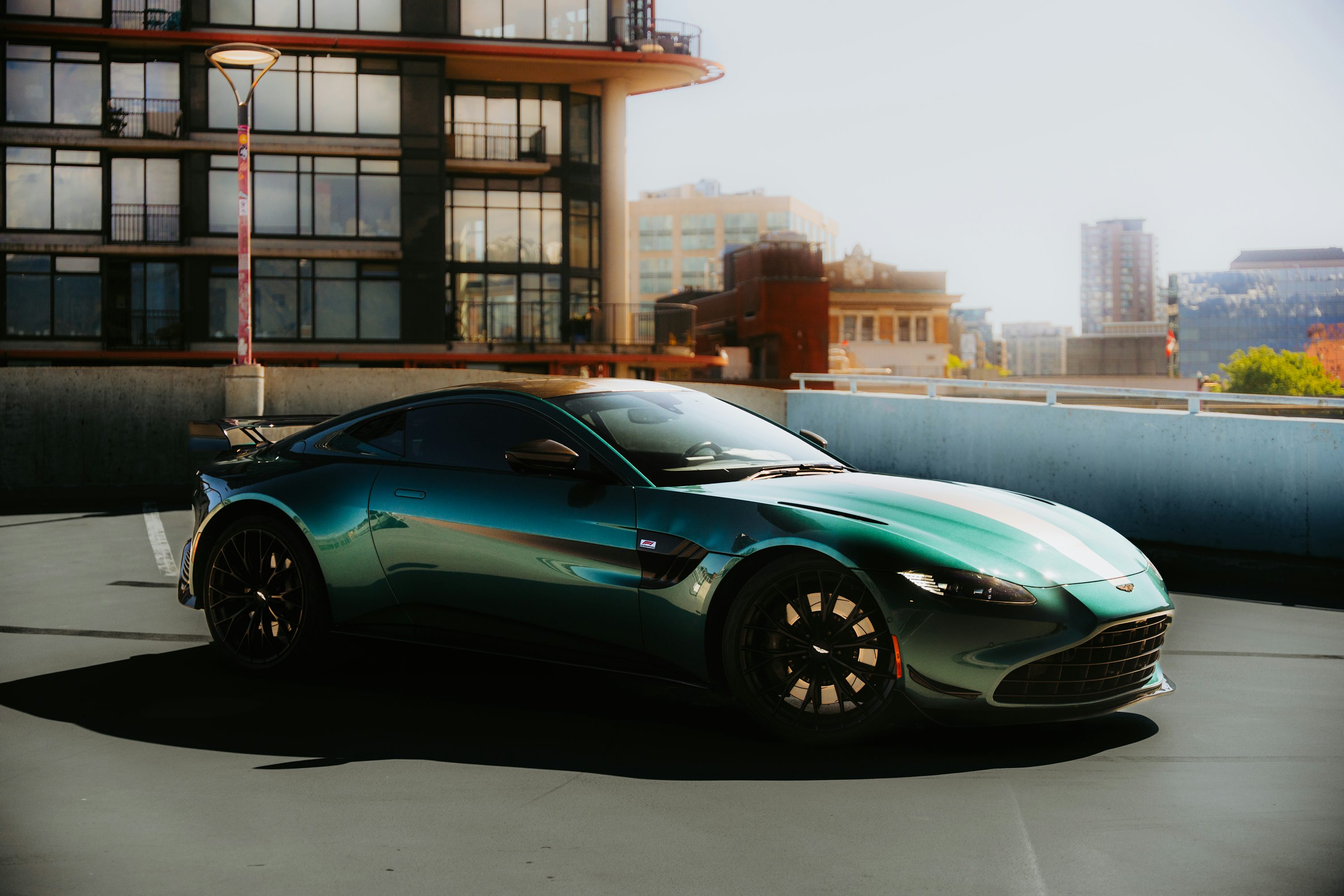 A green sports car is parked on a rooftop.