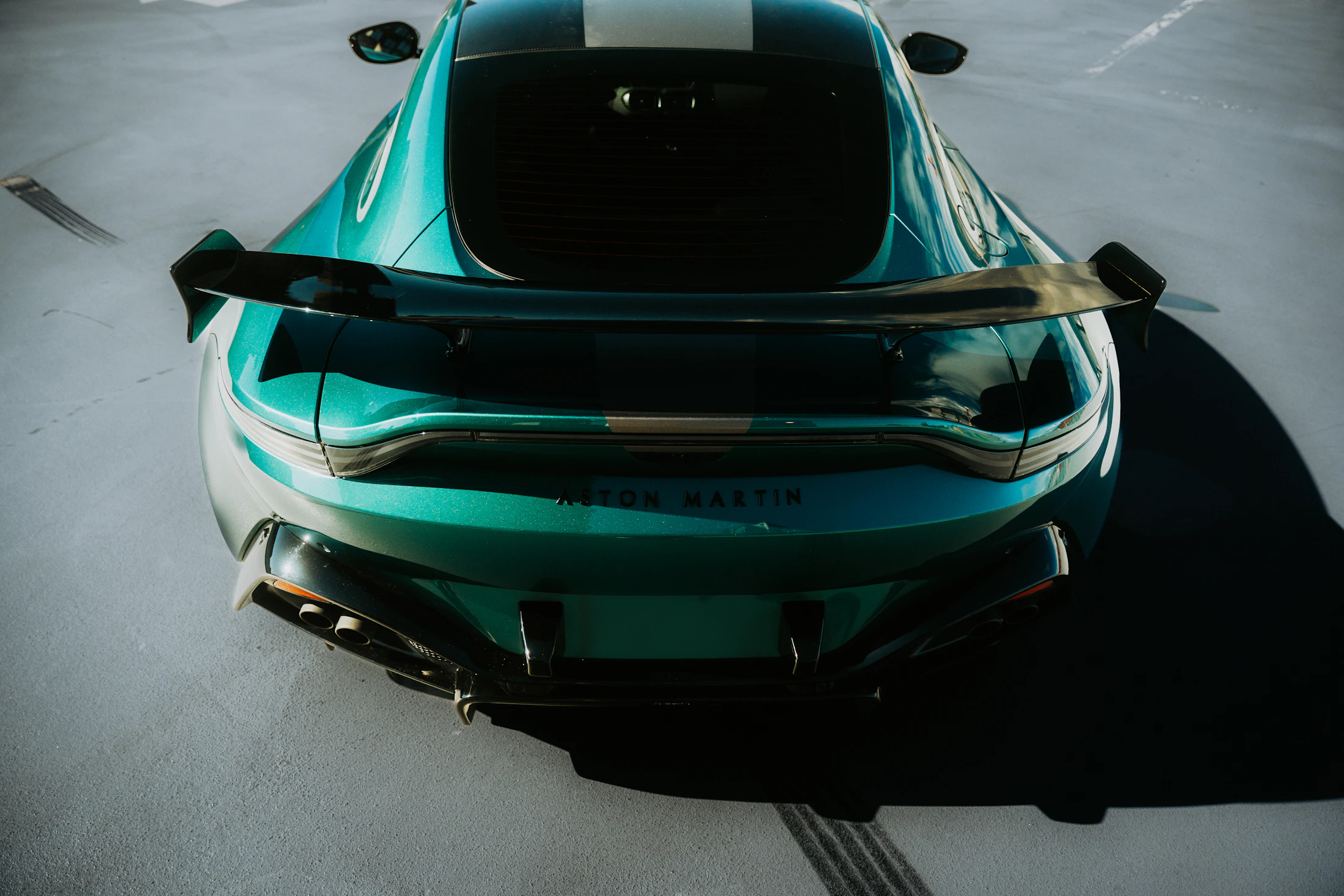 Overhead view of a rich green Aston Martin paint finish in daylight