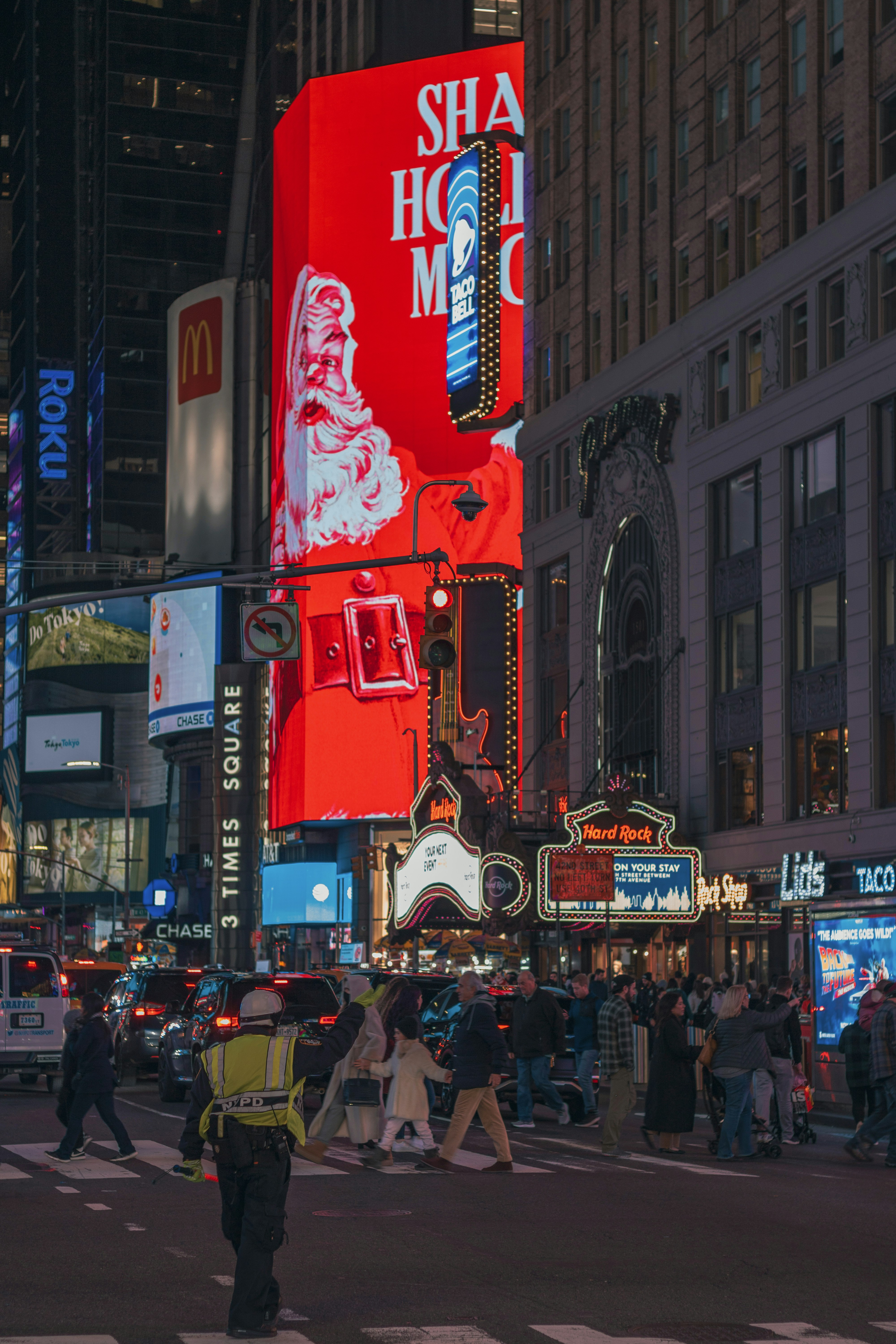 Times square illuminated with bright billboards at night.
