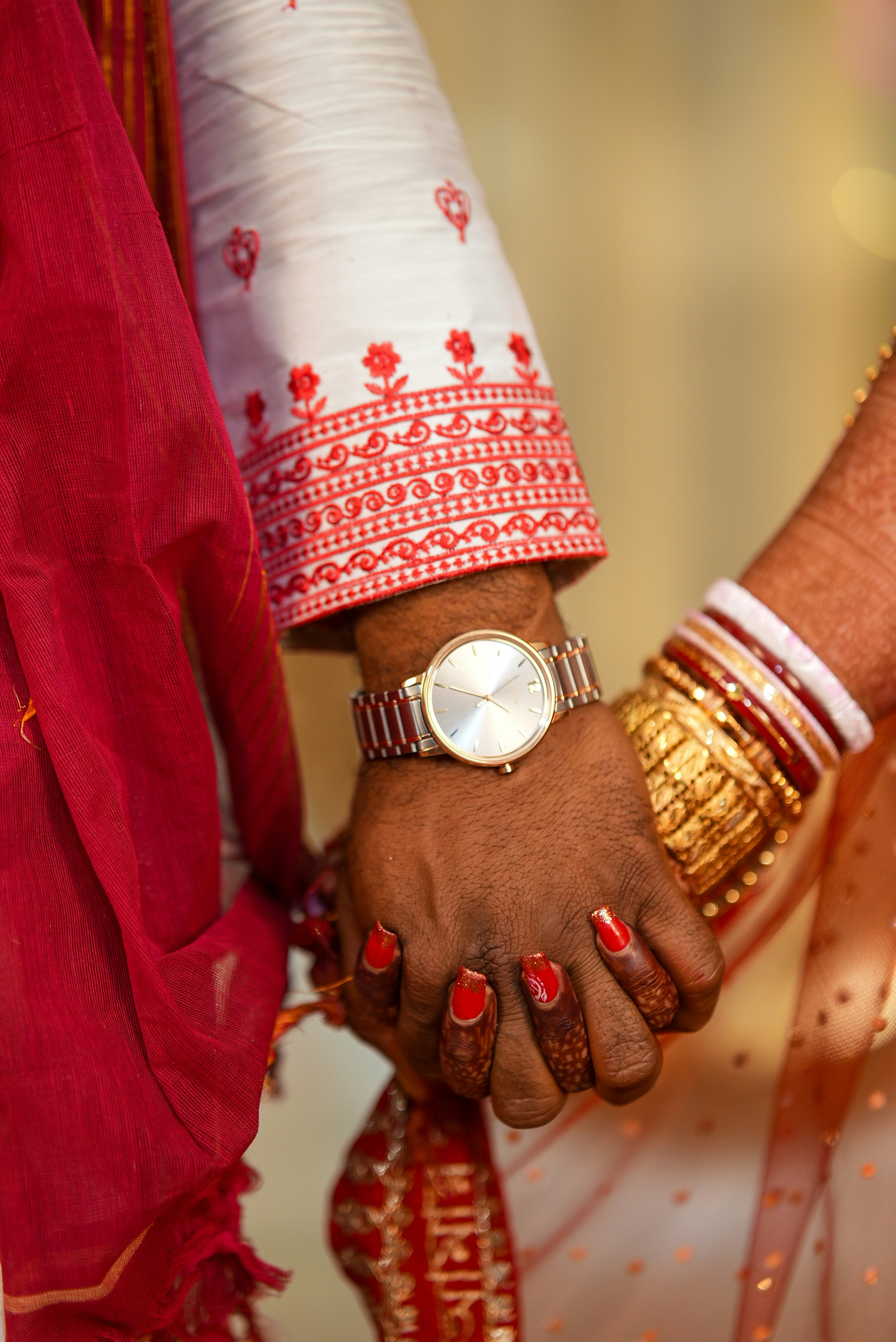 A couple holds hands during their wedding ceremony.