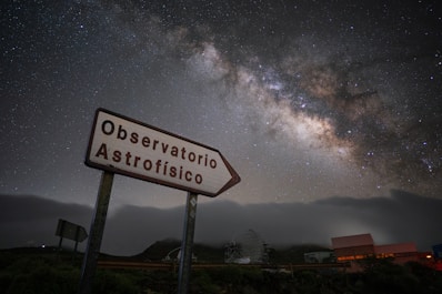 Sign points to the observatory beneath the milky way.
