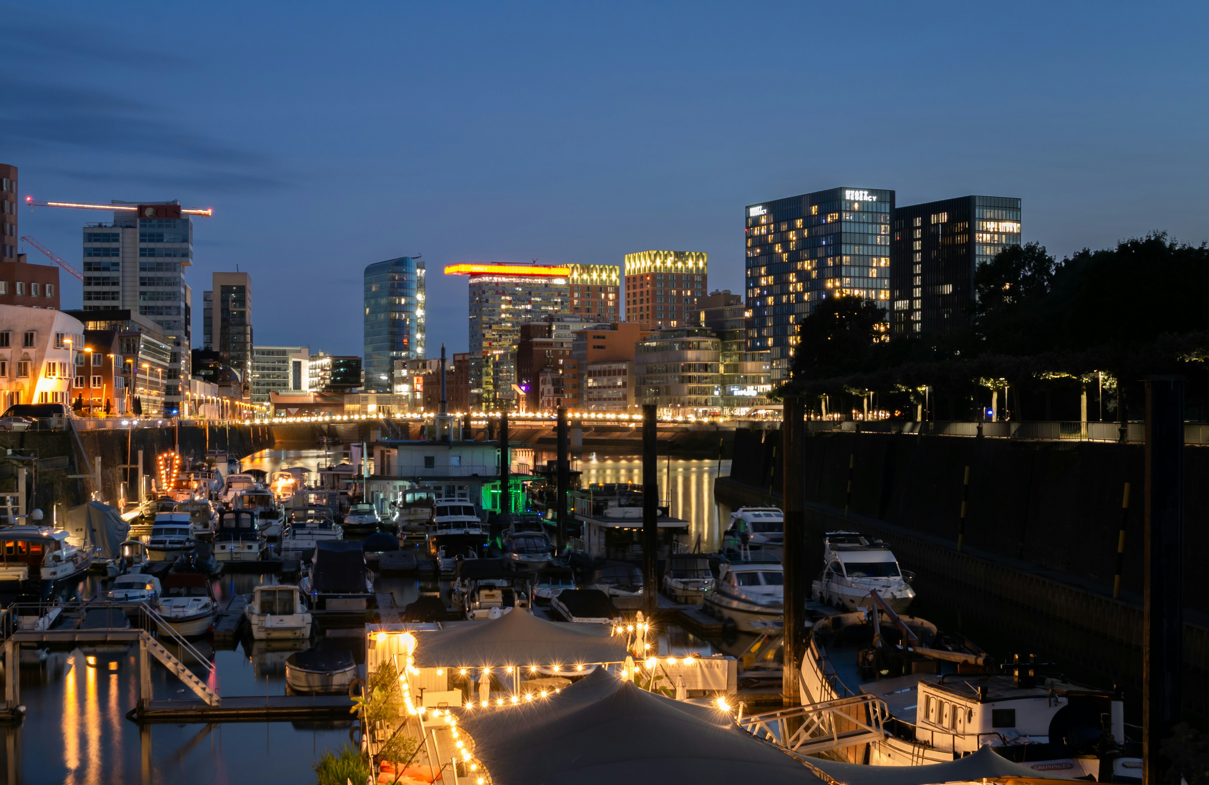 A city harbor at night with bright lights.
