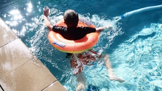 A child floats in a pool with an inflatable.