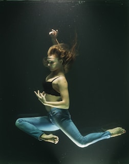 Woman poses gracefully while underwater.