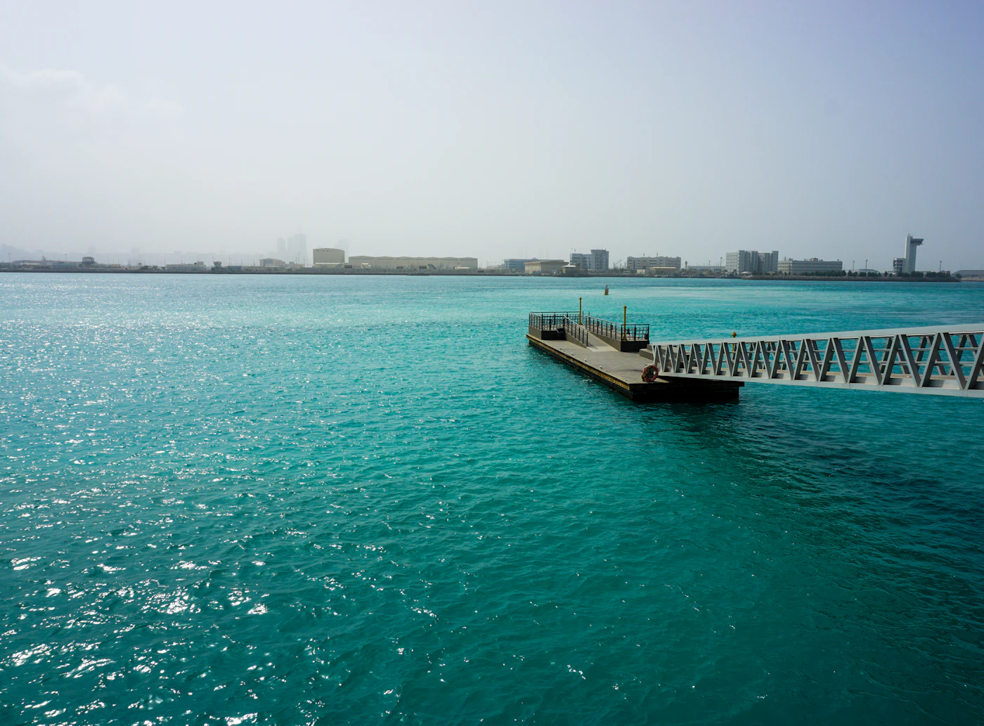 A pier extending into turquoise water off an Abu Dhabi island