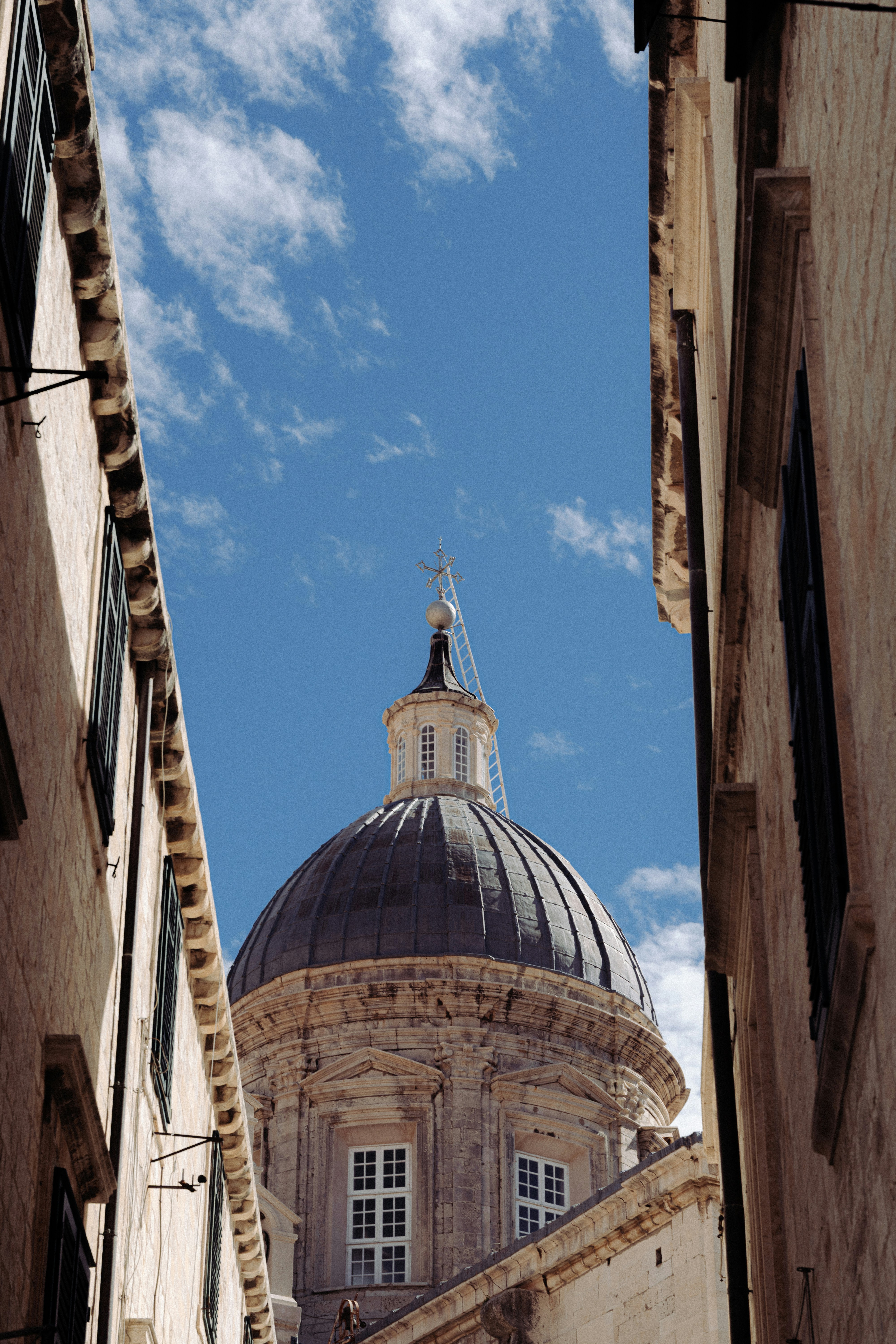 Dome of a building framed by walls.