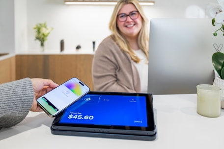 A phone is used to pay at the counter.