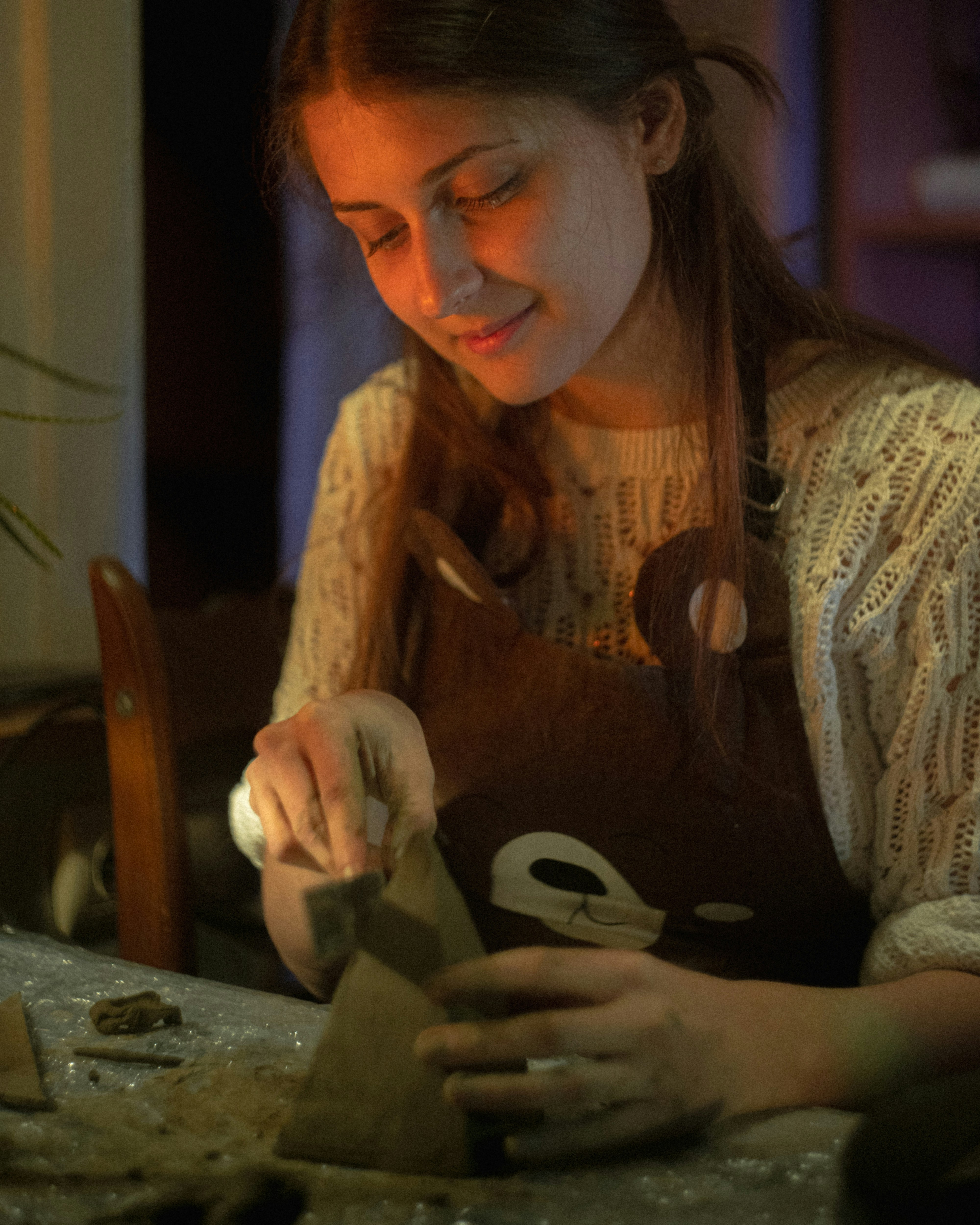 A woman is working on a craft project.