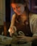 A woman is working on a craft project.