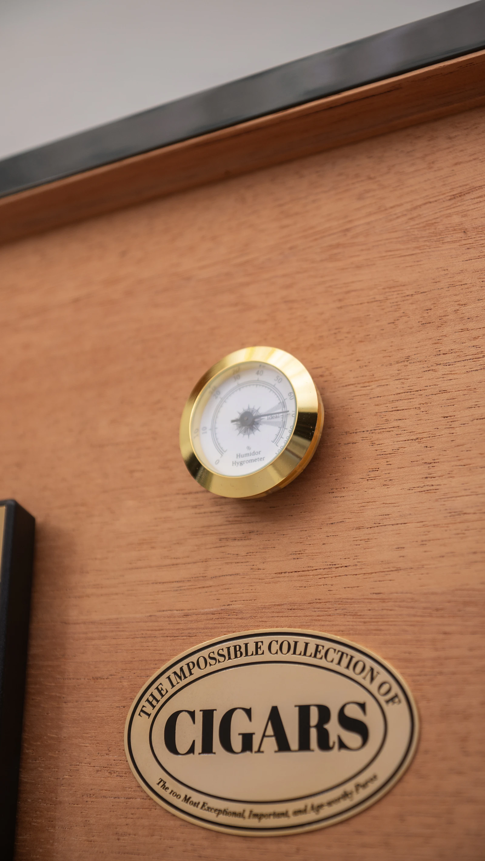 Open humidor with an embedded thermometer in deep moody tones
