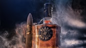 A bottle of bourbon and a cigar.