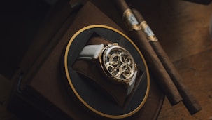 A luxury watch and cigars on display.