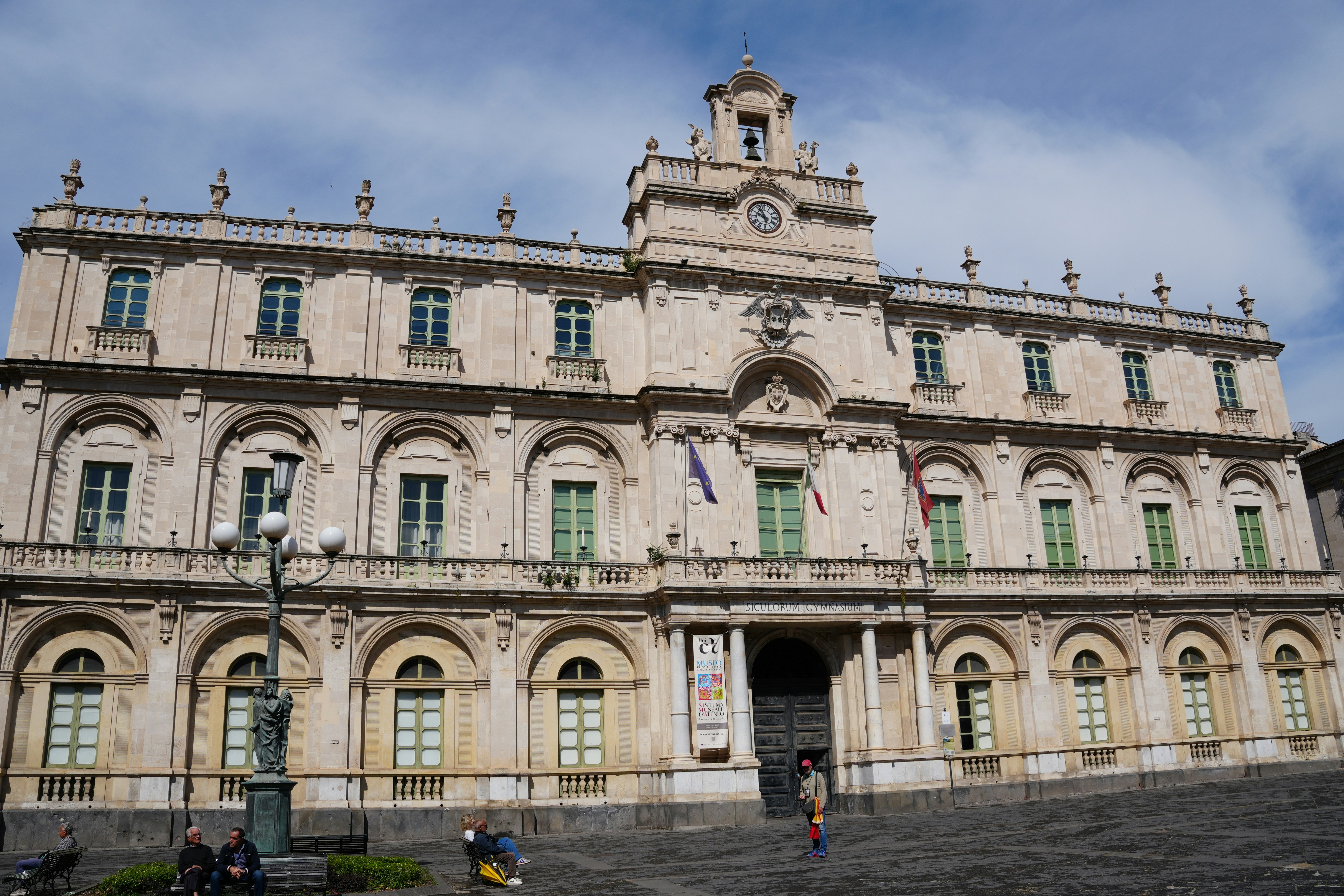 A grand, historic building stands under a blue sky.