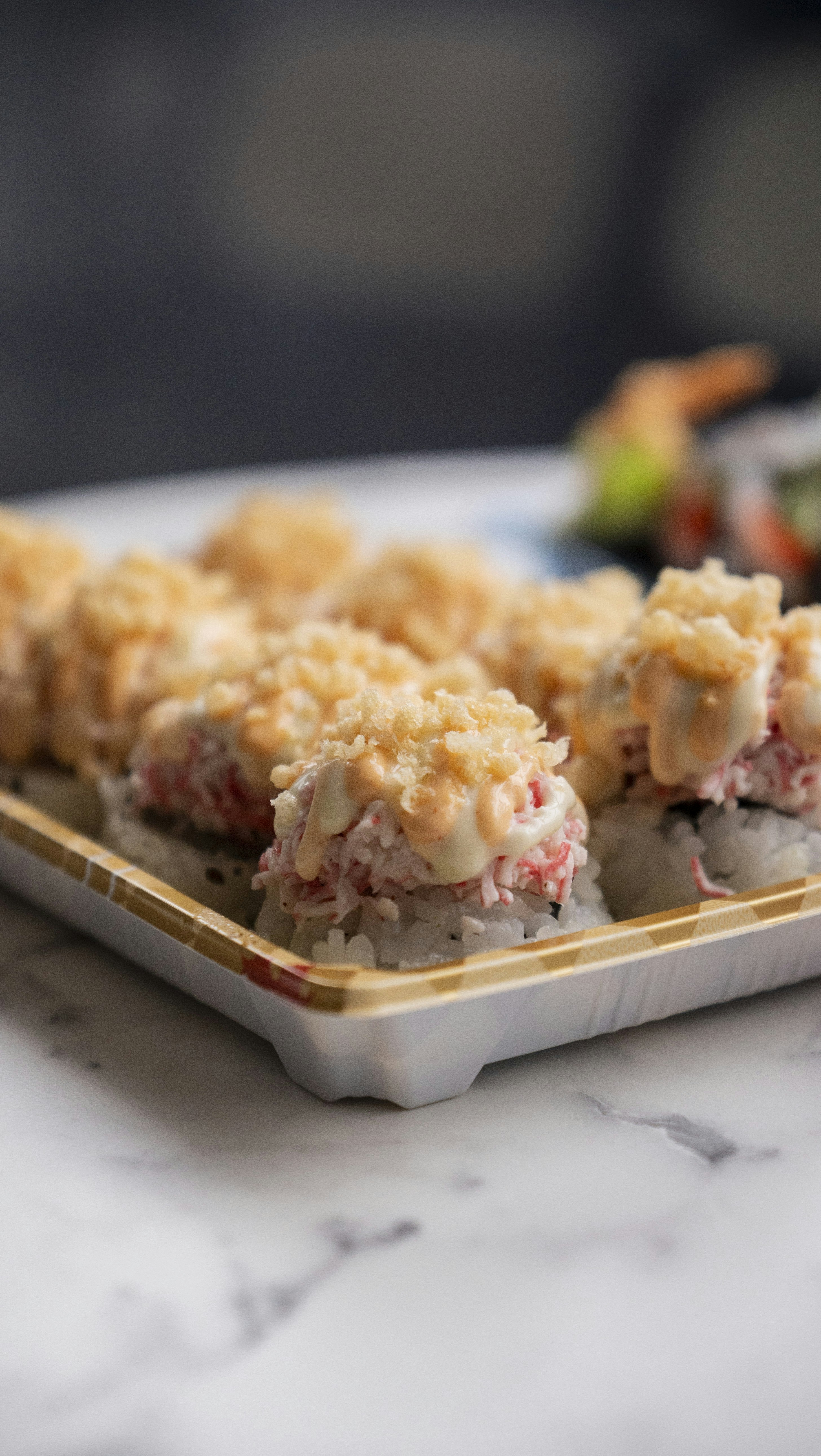 Delicious sushi rolls are arranged on a white plate.