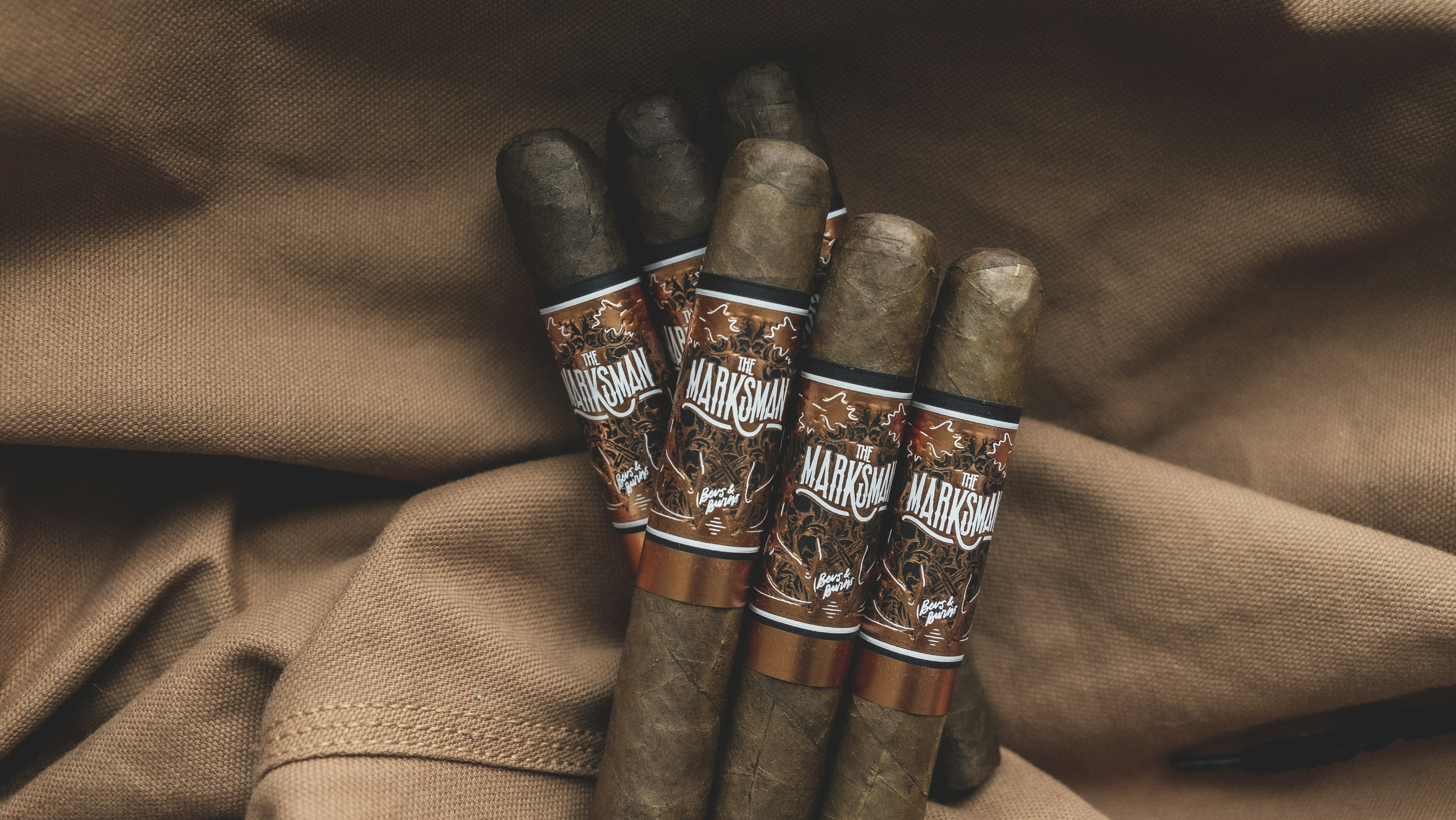 Cigars on brown fabric