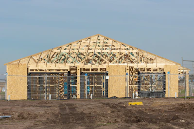 A building is under construction with exposed framing.