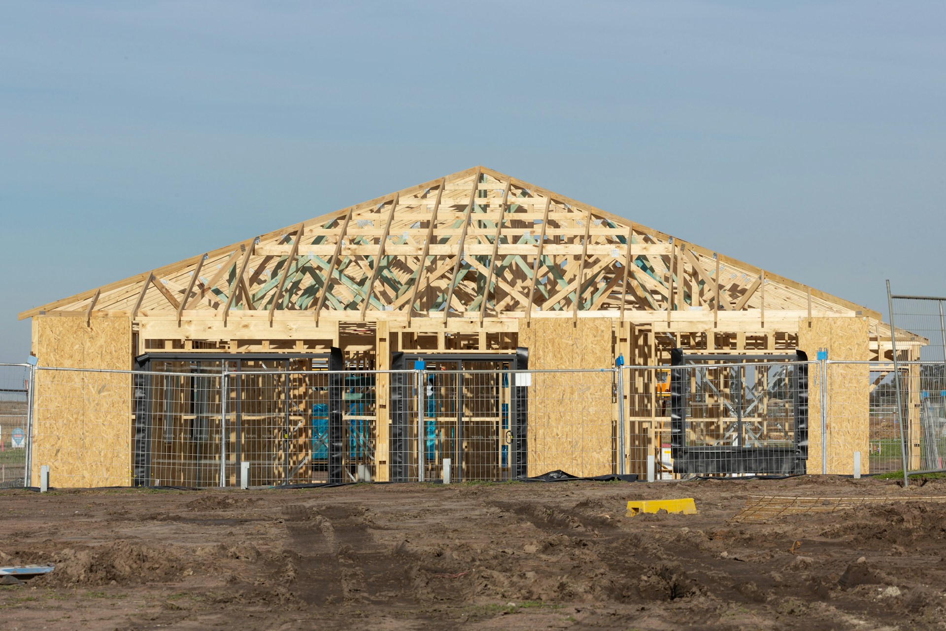A building is under construction with exposed framing.