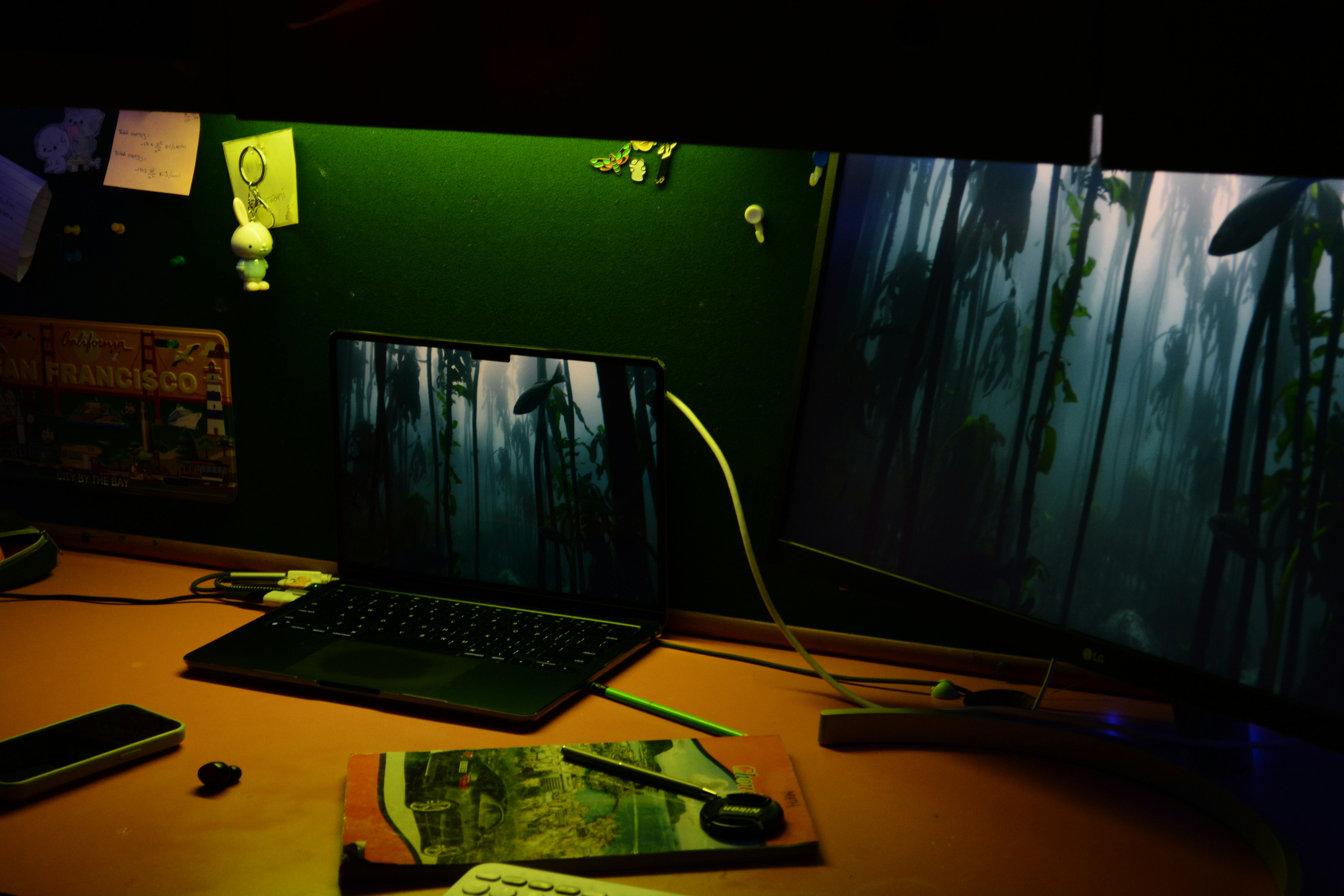 The glow of a smartphone screen reflecting on a modern office desk at night