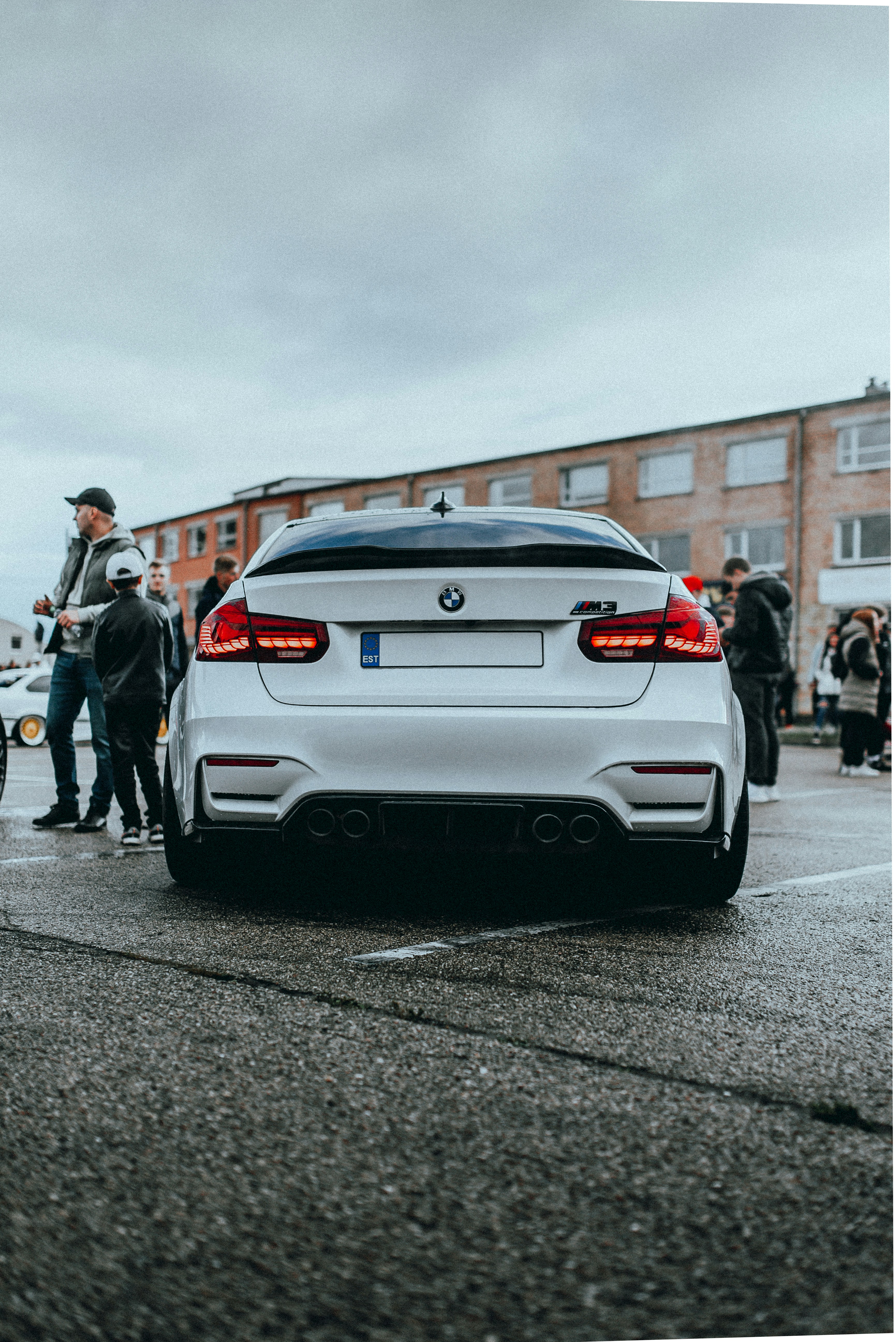 A white BMW car is shown at an event