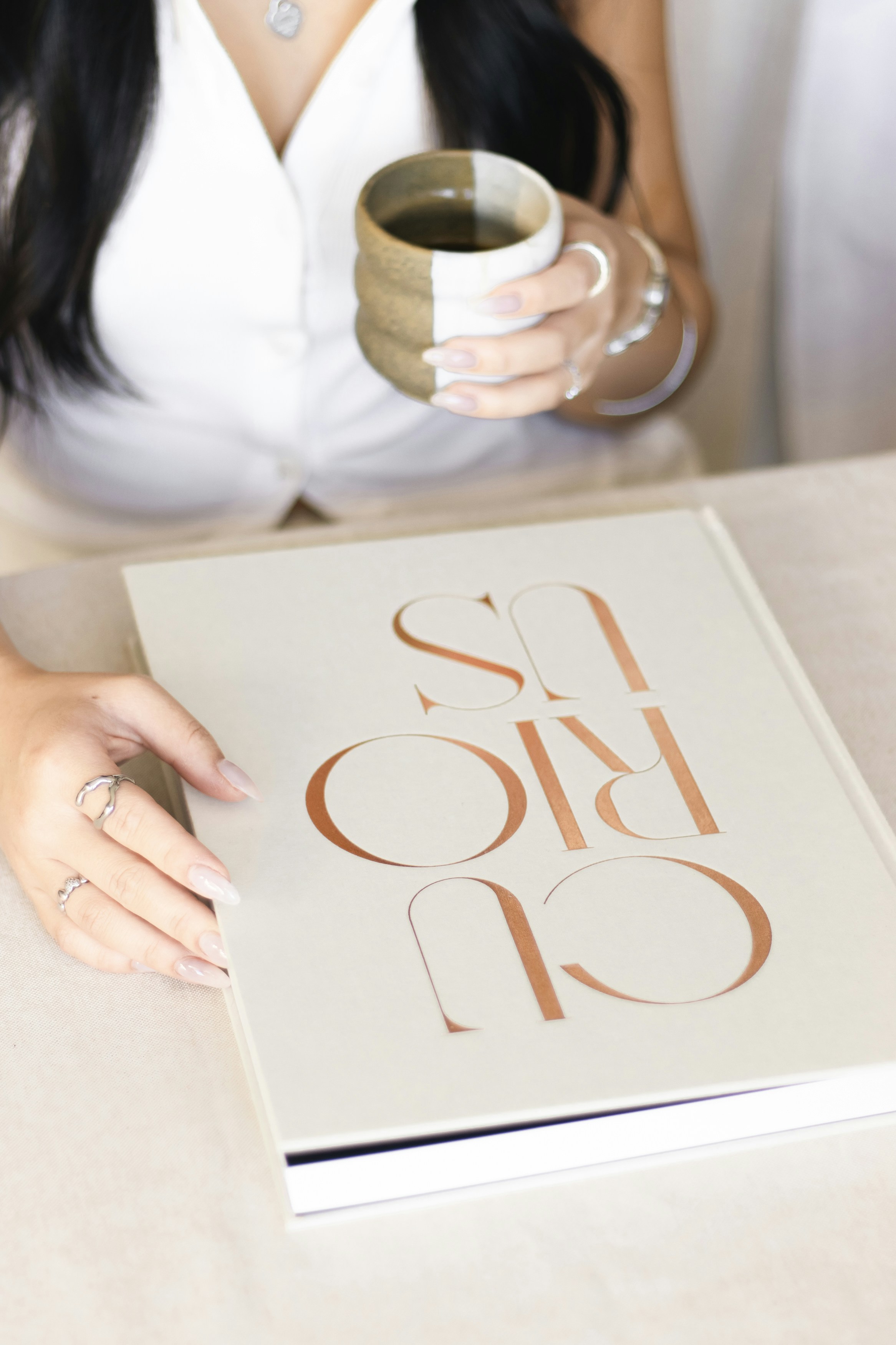 Woman enjoys a book and a cup of tea.