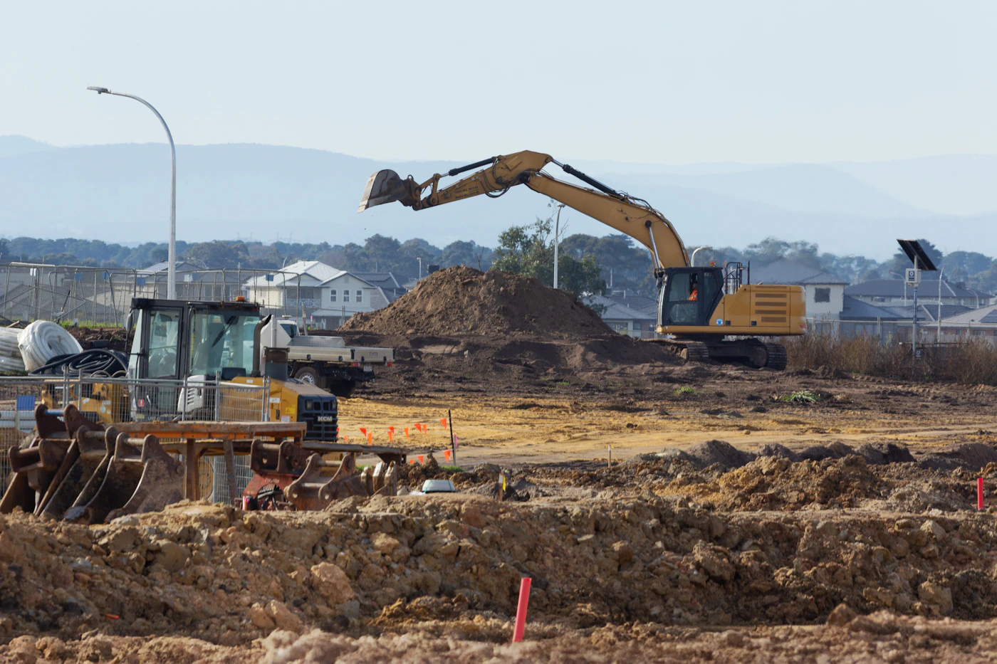 Excavator performing site work