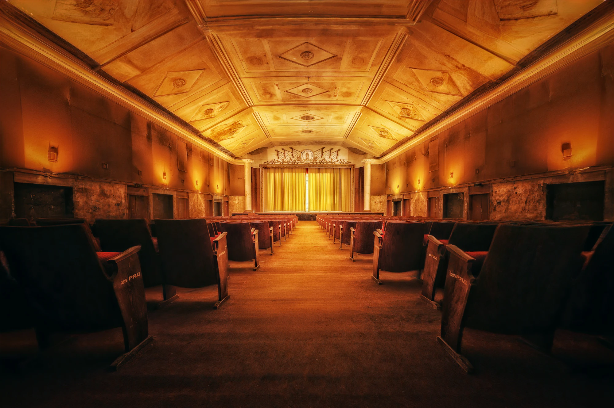 Cinema with warm gold lighting and velvet seats
