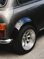 Here is a short caption: an up-close view of a mini cooper's wheel.