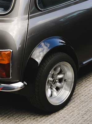 Here is a short caption: an up-close view of a mini cooper's wheel.