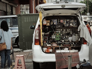 A van displays various tools and supplies for sale.