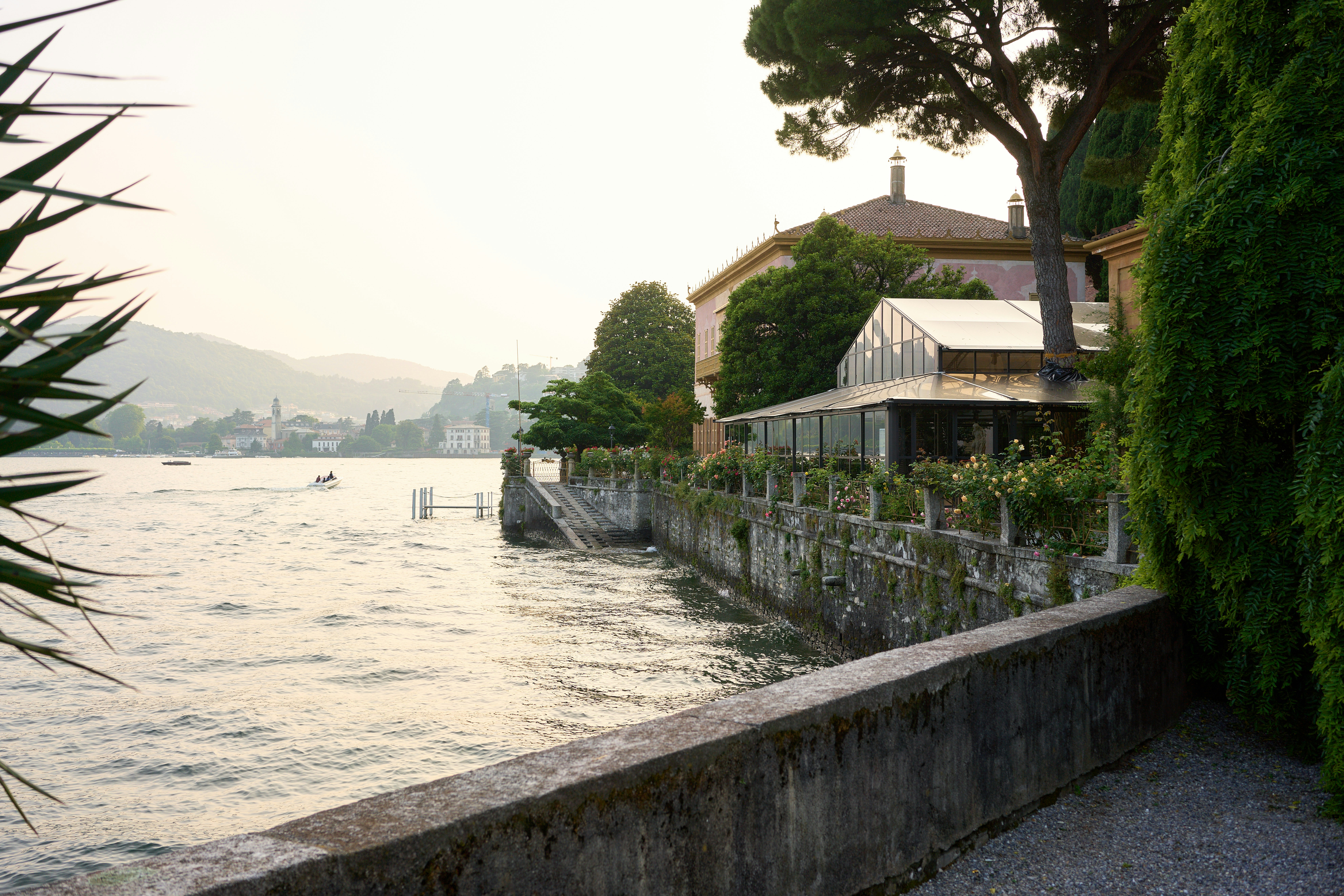 A building and the sea under a hazy sky.
