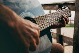 Someone is playing a blue acoustic guitar.