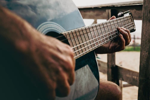 Someone is playing a blue acoustic guitar.