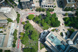 People gather in a city square.