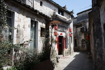 A narrow alleyway leads between old stone buildings.